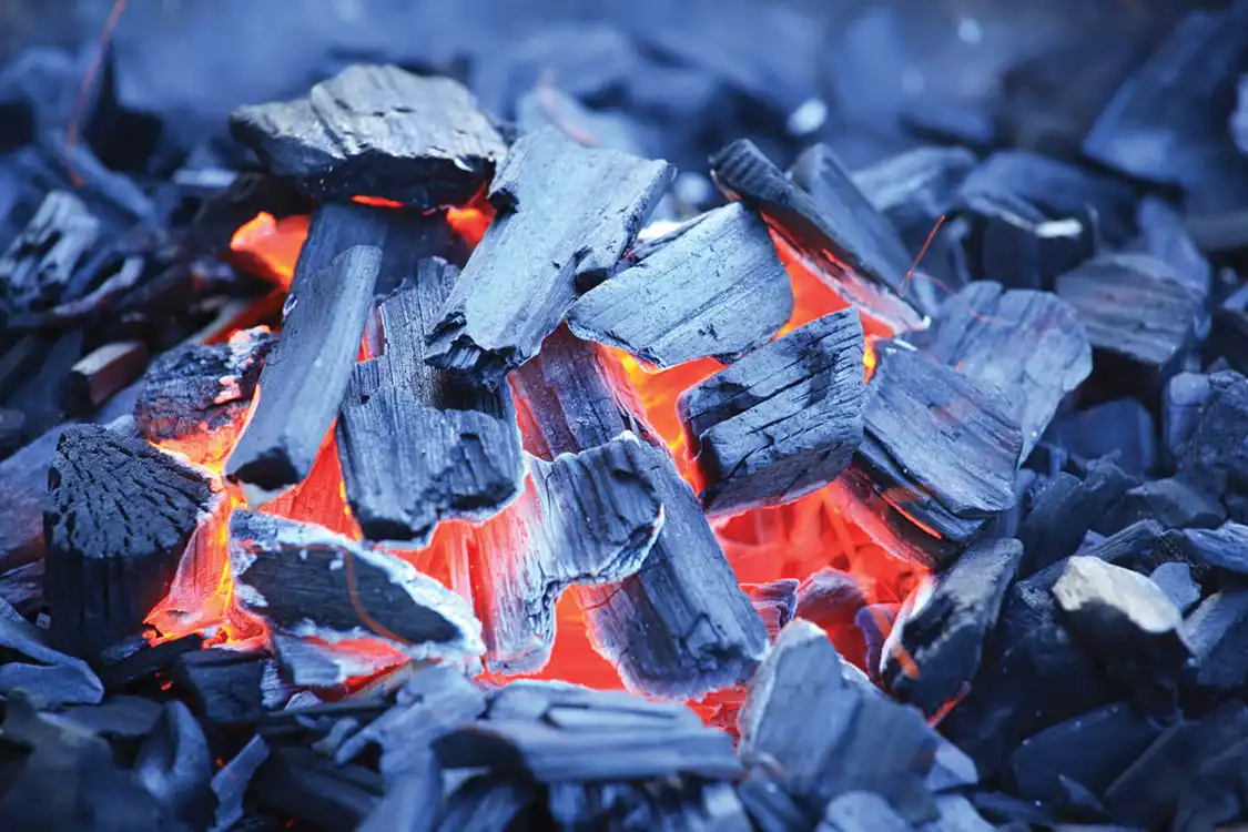 When waiting for your fire to mature, look for the orange-pink glow in between the wood chips. Excessive smoke should subside, as well.