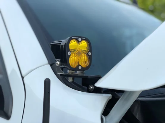 The SDHQ A-Pillar light mounts a light to the front windshield of a white truck.