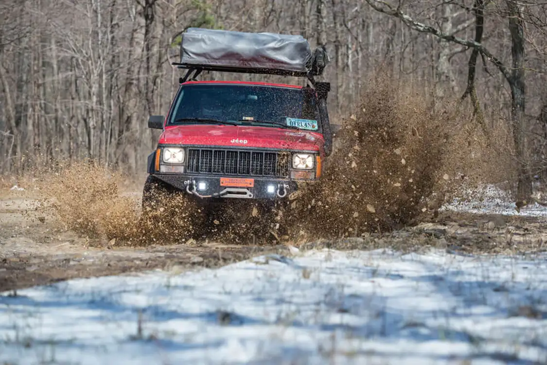 The front bumper houses a Warn M-8000 winch