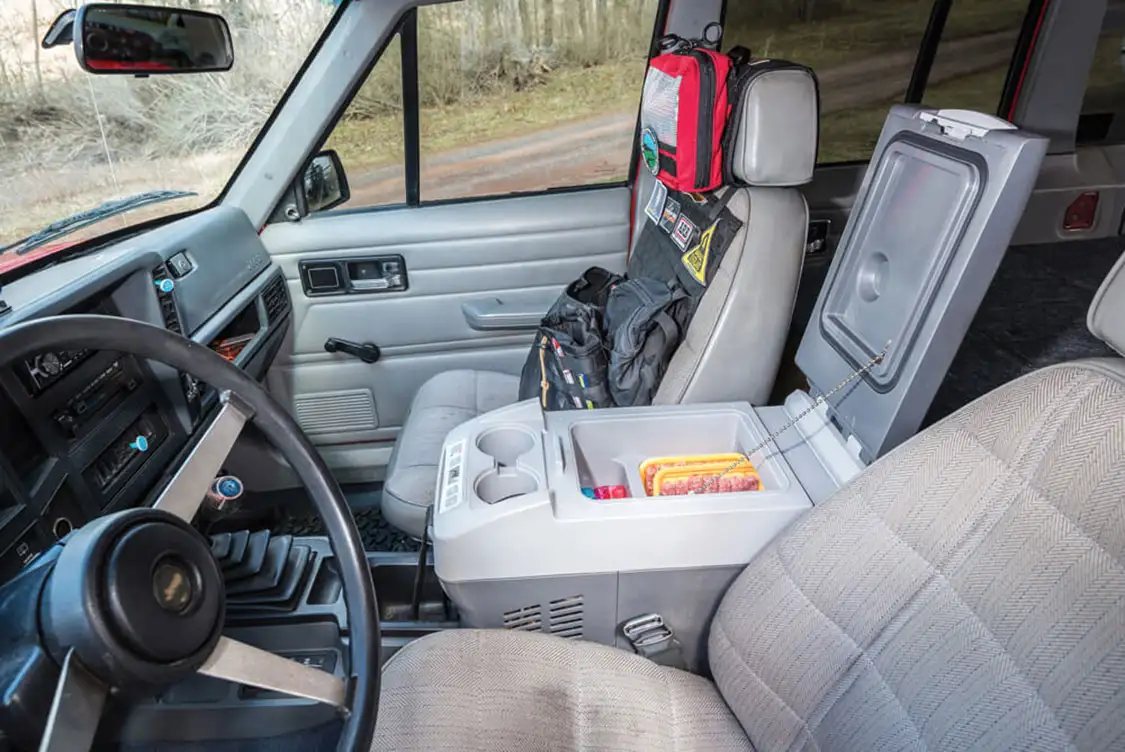 A Dometic fridge/freezer is installed between the seats