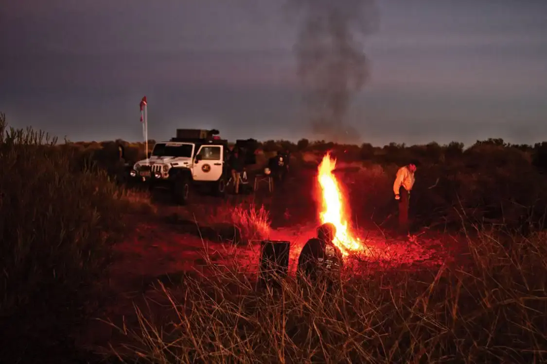 Jeep Convoy camps in Australian night with fire