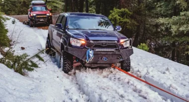 Toyota being pulled out of snow using a recovery rope