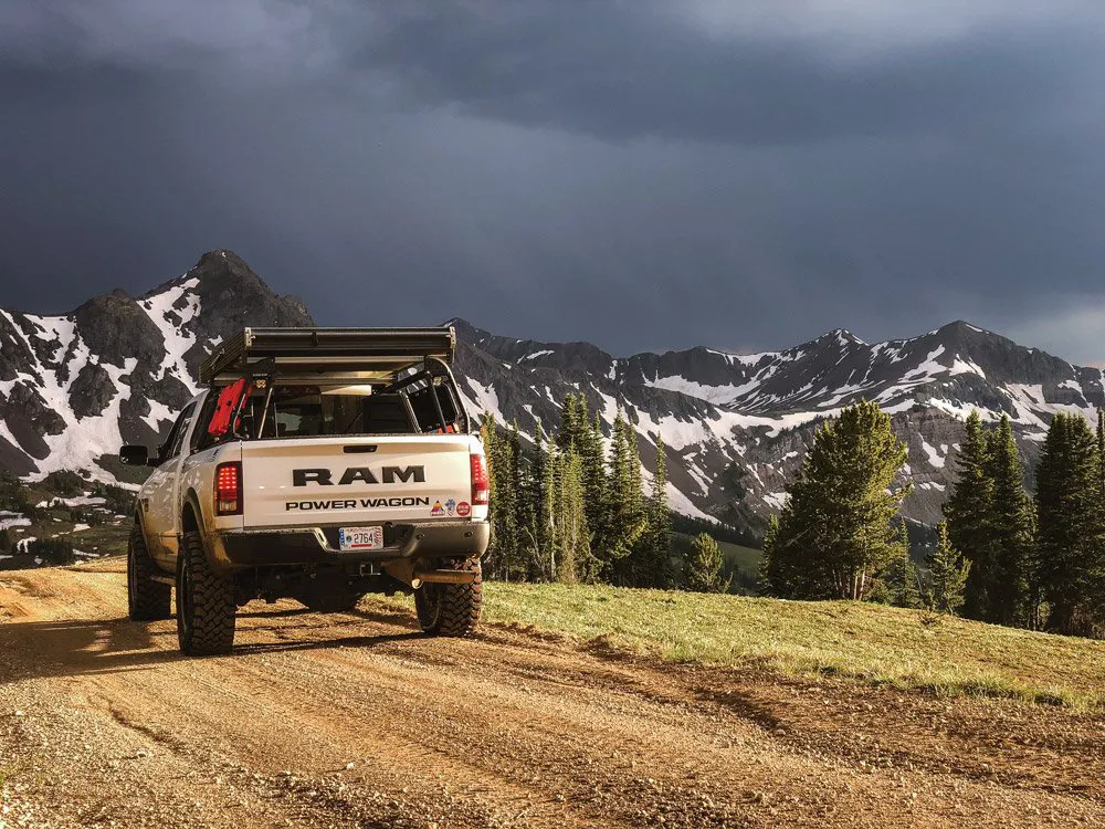 Dodge Ram truck driving into the mountains with fridge inside