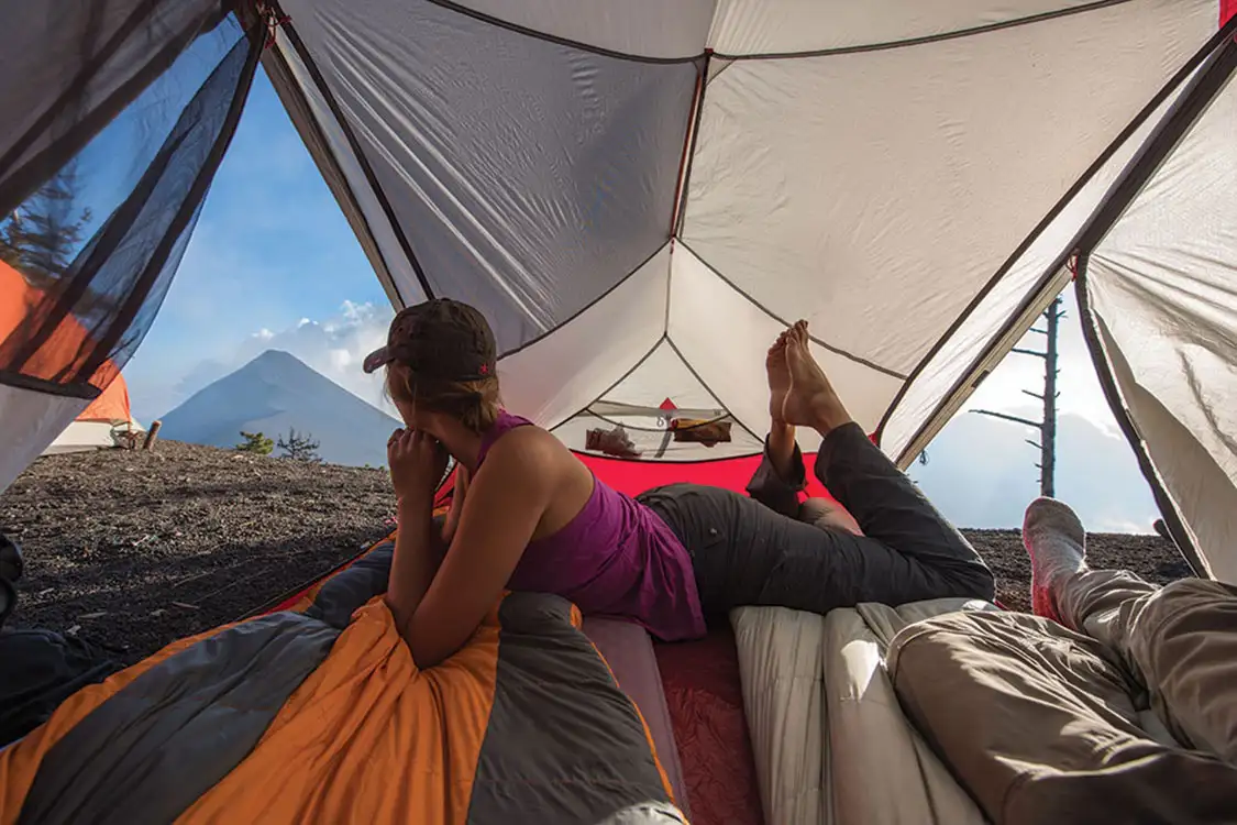 Taisa looks out of the rooftop tent