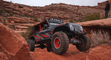 Jeep driving on red rocks in Moab, Utah.