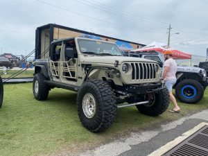 Khaki Jeep Gladiator with open doors.